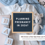 A flat lay photo featuring baby blocks spelling 'BABY,' a white baby outfit, a knitted stuffed bunny, and a blue blanket. In the center, a framed letter board reads 'Planning Pregnancy in 2026?' The image also includes text promoting tips on pregnancy planning from MassageLuxe, with the website www.massageluxe.com/wellnessresources ."