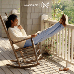 Woman relaxing in a wooden rocking chair on a sunlit porch, reading and enjoying a peaceful summer moment outdoors. MassageLuXe logo displayed at the top of the image.