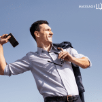 man throwing phone with a smile on his face