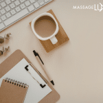 clip board and coffee cup by a laptop