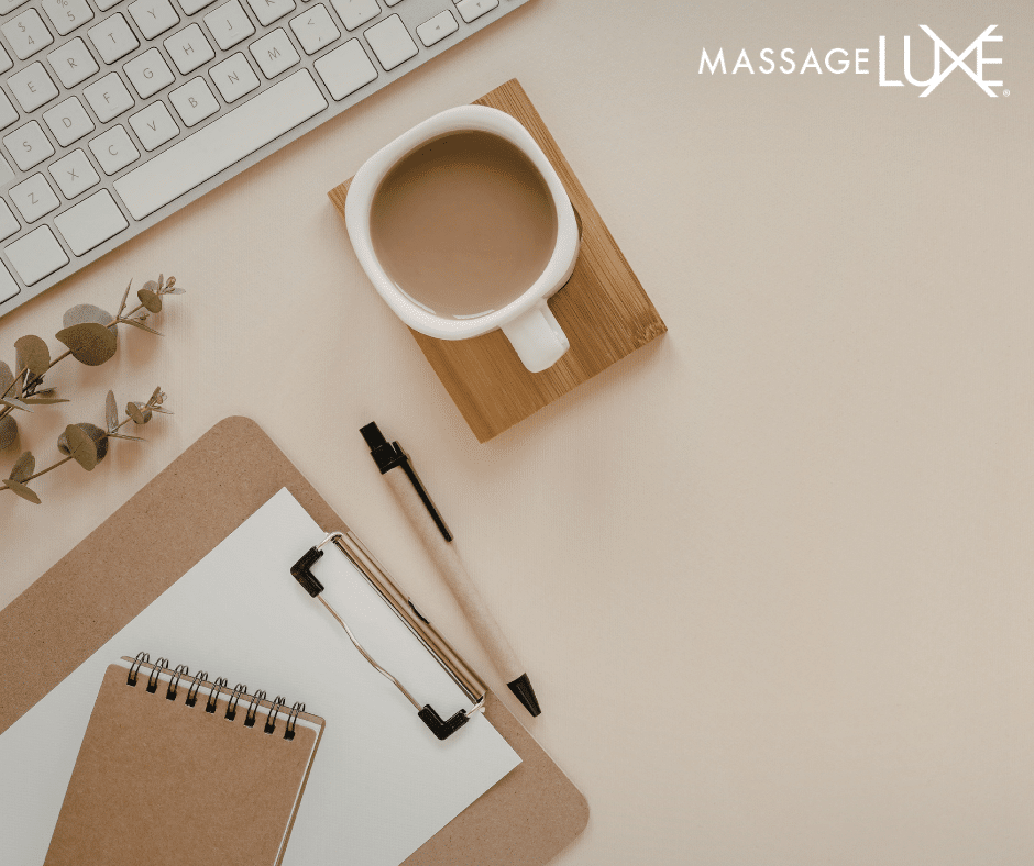 clip board and coffee cup by a laptop